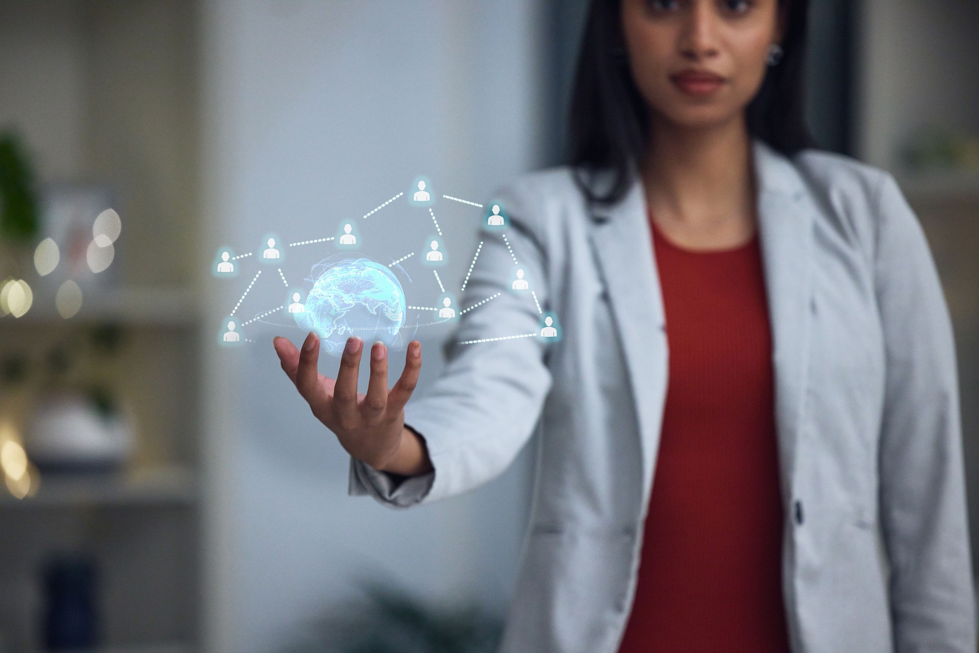 Businesswoman holding a digital globe, tech and networking at the office in the future. Big data, ai and a virtual sphere and social hologram showing connections between people.